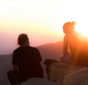 Man and woman talking at sunrise